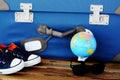 Time to prepare for holiday with retro suitcase, passport, sneakers and globe on wooden table Ã¢â¬â travel concept Royalty Free Stock Photo